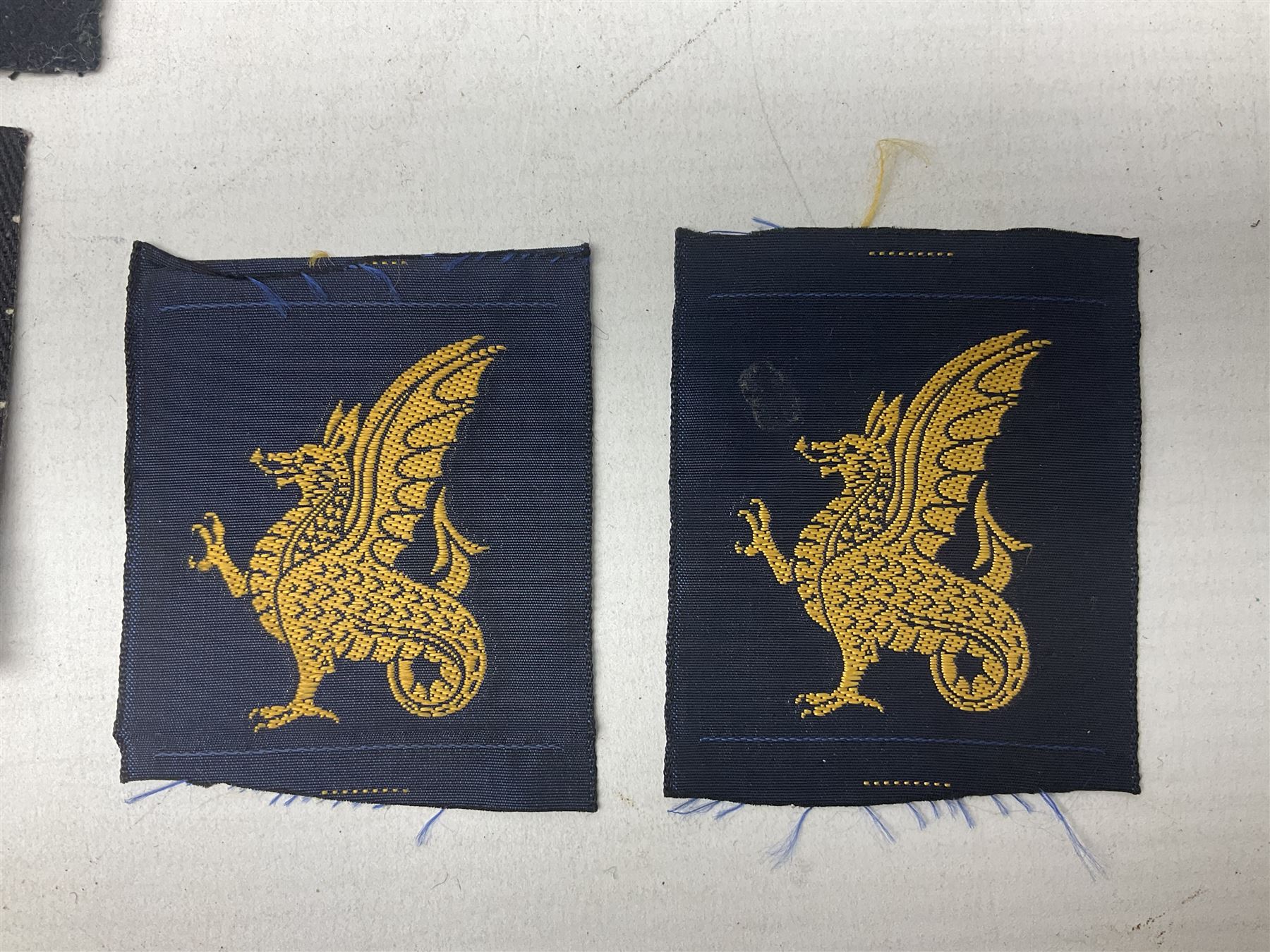 Royal Arms cloth arm adge as worn by Regimental Serjeant-Majors in Foot Guards; naval cap badge; WW2 Commando/Special Forces cloth badges; Home Guard and LDV shoulder titles; and other cloth badges including armoured division, 45th and 77th division, 52nd Lowland Mountain division etc; and 24th Infantry Brigade airmobile pennant