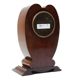 Edwardian- 8-day heart-shaped mahogany bedside table clock with decorative contrasting inlay c1905, white enamel dial with Arabic numerals, minute markers and steel spade hands, French timepiece movement with a later replacement lever platform escapement, wound and set from the rear. With key. 