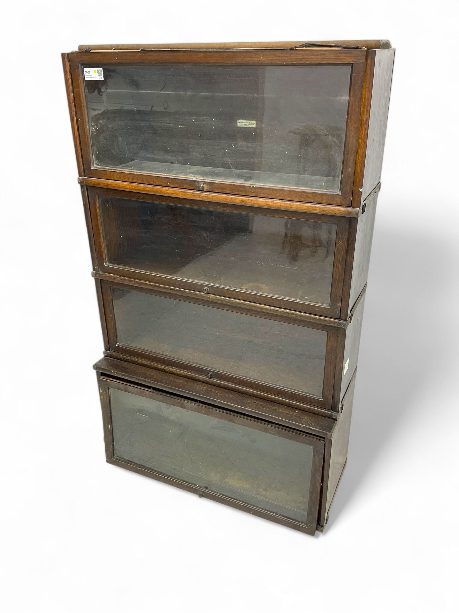 Globe Wernicke - early 20th century oak four-tier stacking library bookcase, four glazed sections enclosed by hinged and sliding doors