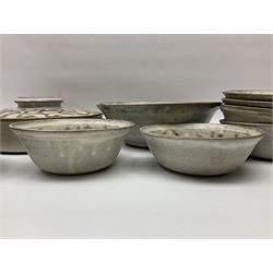 John Egerton (c1945-): studio pottery stoneware, comprising twin shallow covered dish, serving bowl and eight dessert bowls, all decorated with flowering sprigs on a cream ground, dish D28cm