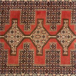 North West Persian Senneh hand-knotted runner, decorated with a continuous series of stepped and hooked geometric medallions against a madder red ground, enclosing herati style and small geometric floral motifs, framed by a principal border and flanked by multiple narrow guard stripes, with cotton fringe ends 