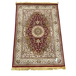 Persian design rug, red ground with central medallion, decorated with scrolling foliate 