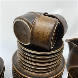 An Arabia Ruska Teaset designed by Ulla Procope, comprising tea pot, twelve tea cups, twelve saucers, twelve plates, milk jug, sucrier and cover, and large jug, together with a large Arabia salad bowl and servers. 