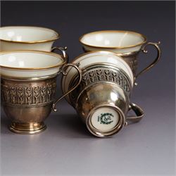Set of six Lenox porcelain coffee cups, with gilt rims, each with American silver openwork cup holders, stamped sterling