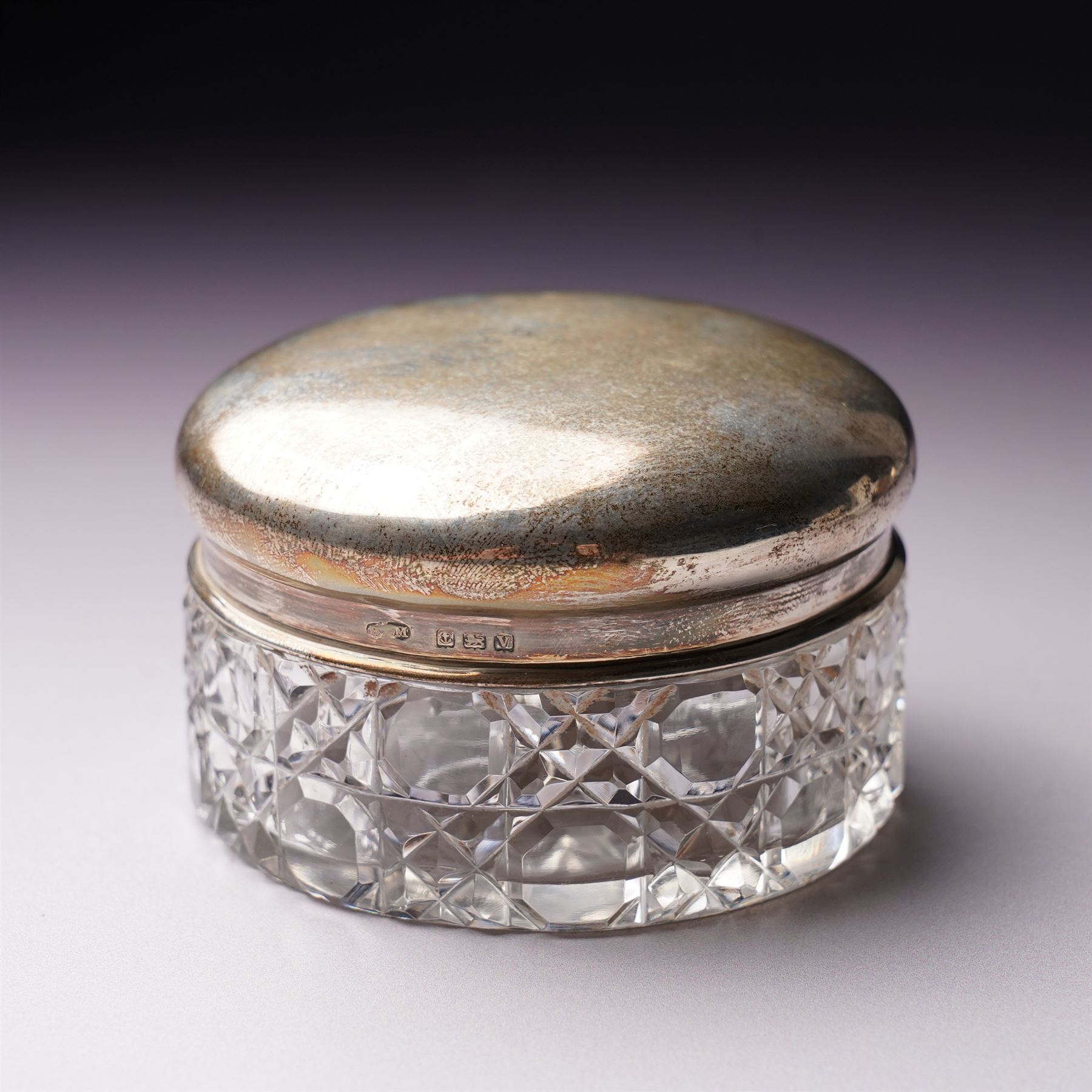 Silver topped glass trinket jar, small circular photograph frame and dessert fork