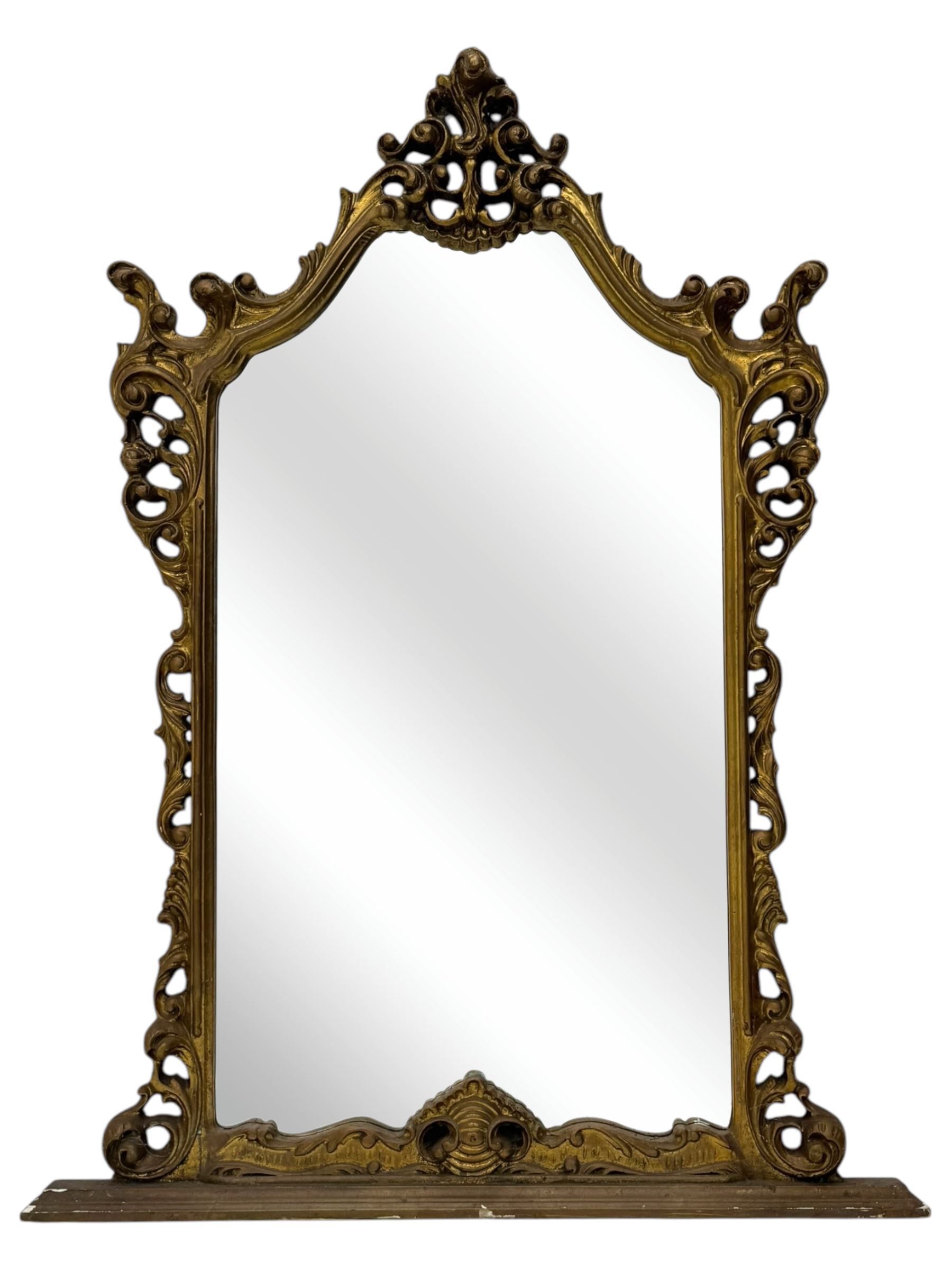 Victorian design gilt framed overmantel mirror, the arched and moulded frame adorned with scrolling foliate motifs and acanthus leaves, surmounted by a pierced cartouche, plain mirror plate, resting on a shaped base
