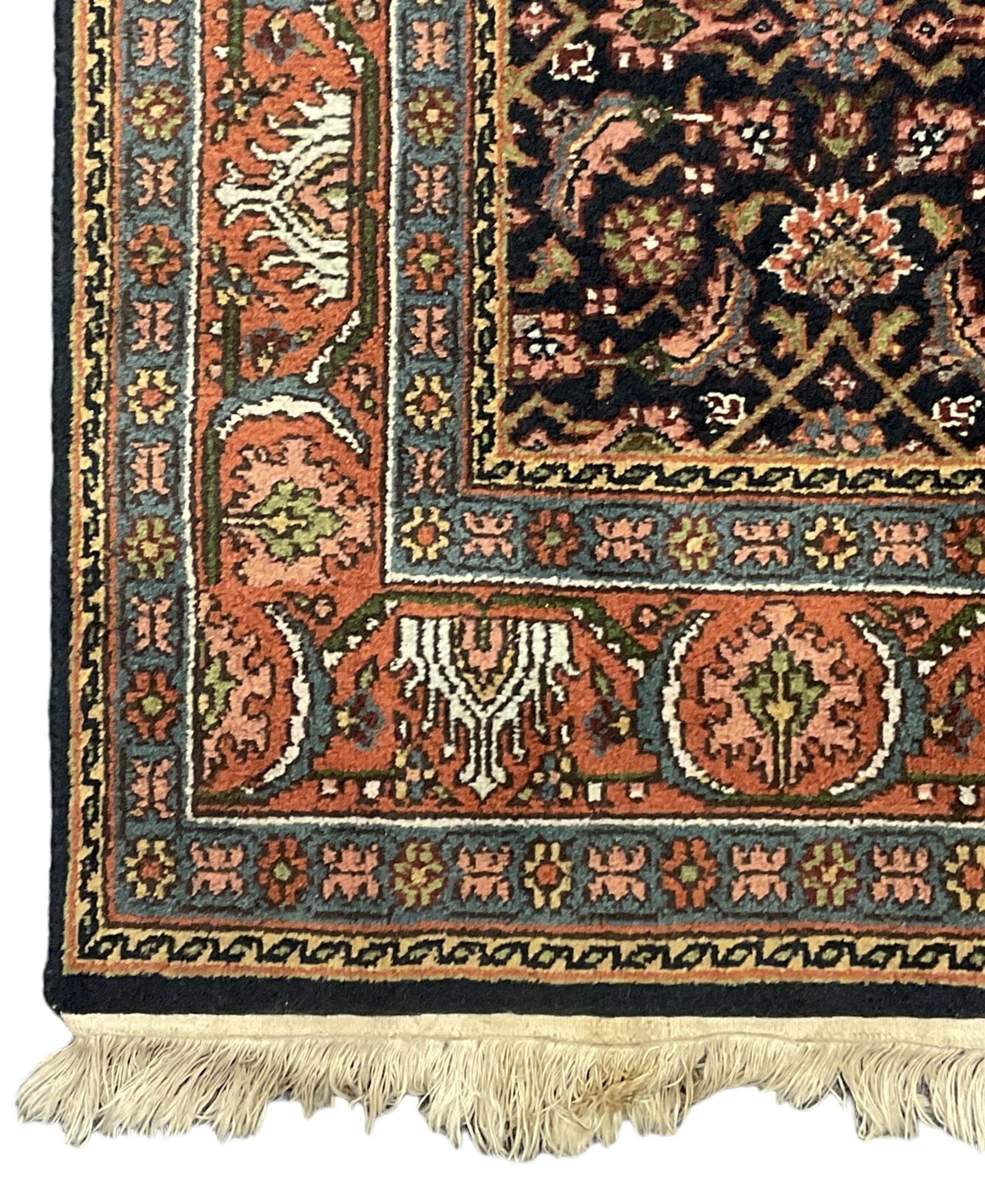 Persian Herati indigo ground rug, the field decorated with repeating Herati motifs, floral design border within guard stripes 