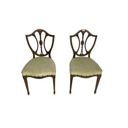 Pair late 19th century rosewood dining chairs, the shield backs pierced and carved with foliate decoration, upholstered seat over serpentine apron, raised on fluted tapered supports terminating in spade feet