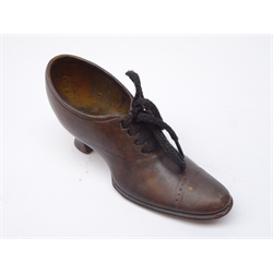 Early 20th century cast bronze model of a ladies court shoe, stamped Geschutzt, L13cm   