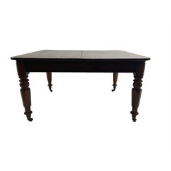 Late 19th century extending mahogany dining table, square top with banded frieze rail, raised on turned octagonal supports with  brass cups and castors, with two additional leaves