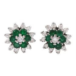 Pair of 18ct white gold emerald and round brilliant cut diamond flower head cluster stud earrings, London 1978 