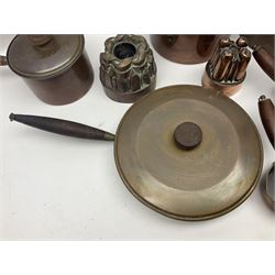 Four Victorian copper moulds, together with a graduating set of copper pans with wooden handles and finials to covers, largest pan 
