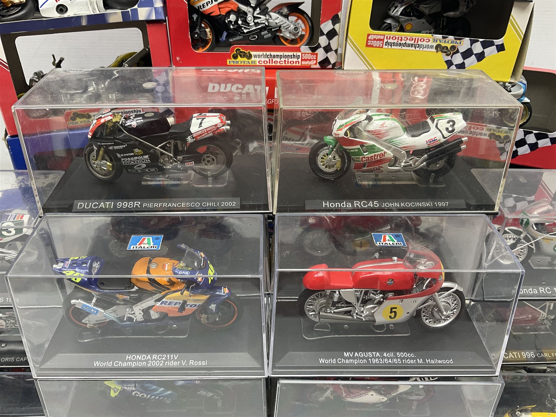 Fifty-one die-cast models of motorcycles by Maisto, Protar Italeri, Welly etc; many in perspex display boxes, some in window boxes and some unboxed