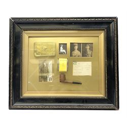 Framed display of a Princess Mary 1914 Christmas tin with greeting card, two pictures of the Princess, original packet of tobacco, smoking pipe and photograph of the recipient in uniform 38 x 47cm; ebonised and gilt frame