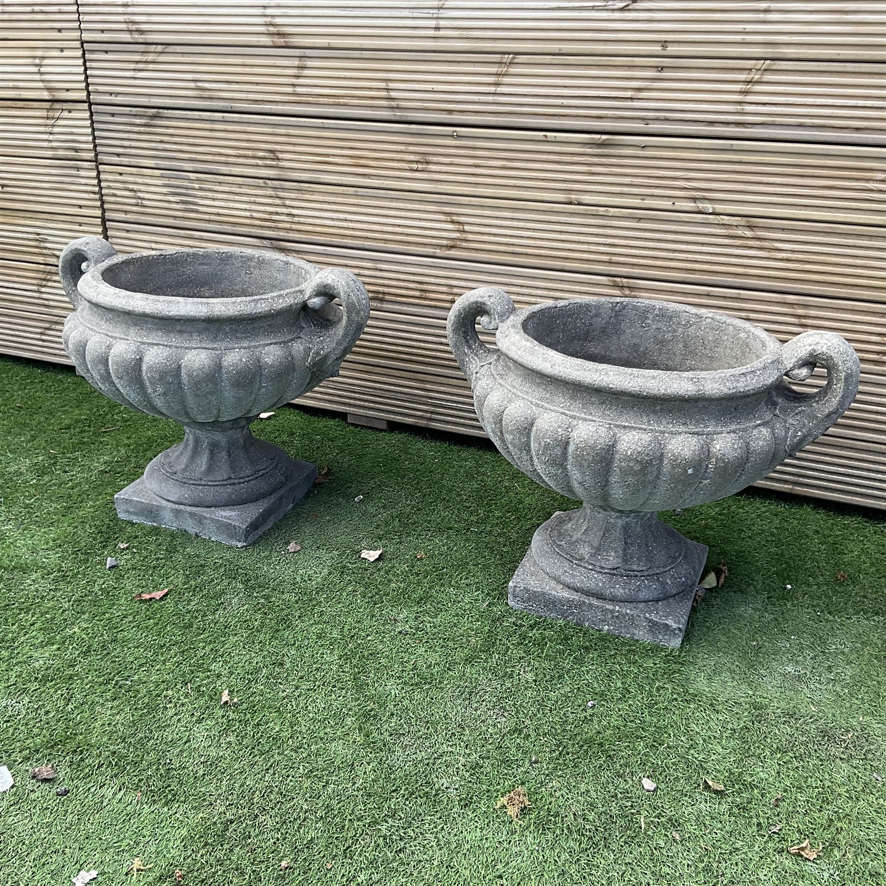 Pair of squat cast stone garden urns, with handles on pedestal  base, D50, H45 - THIS LOT IS TO BE COLLECTED BY APPOINTMENT FROM DUGGLEBY STORAGE, GREAT HILL, EASTFIELD, SCARBOROUGH, YO11 3TX