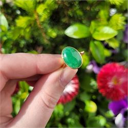 Early - mid 20th century gold jade ring, bezel set with a single oval cabochon jade of approx 4.10 carat, stamped 18ct