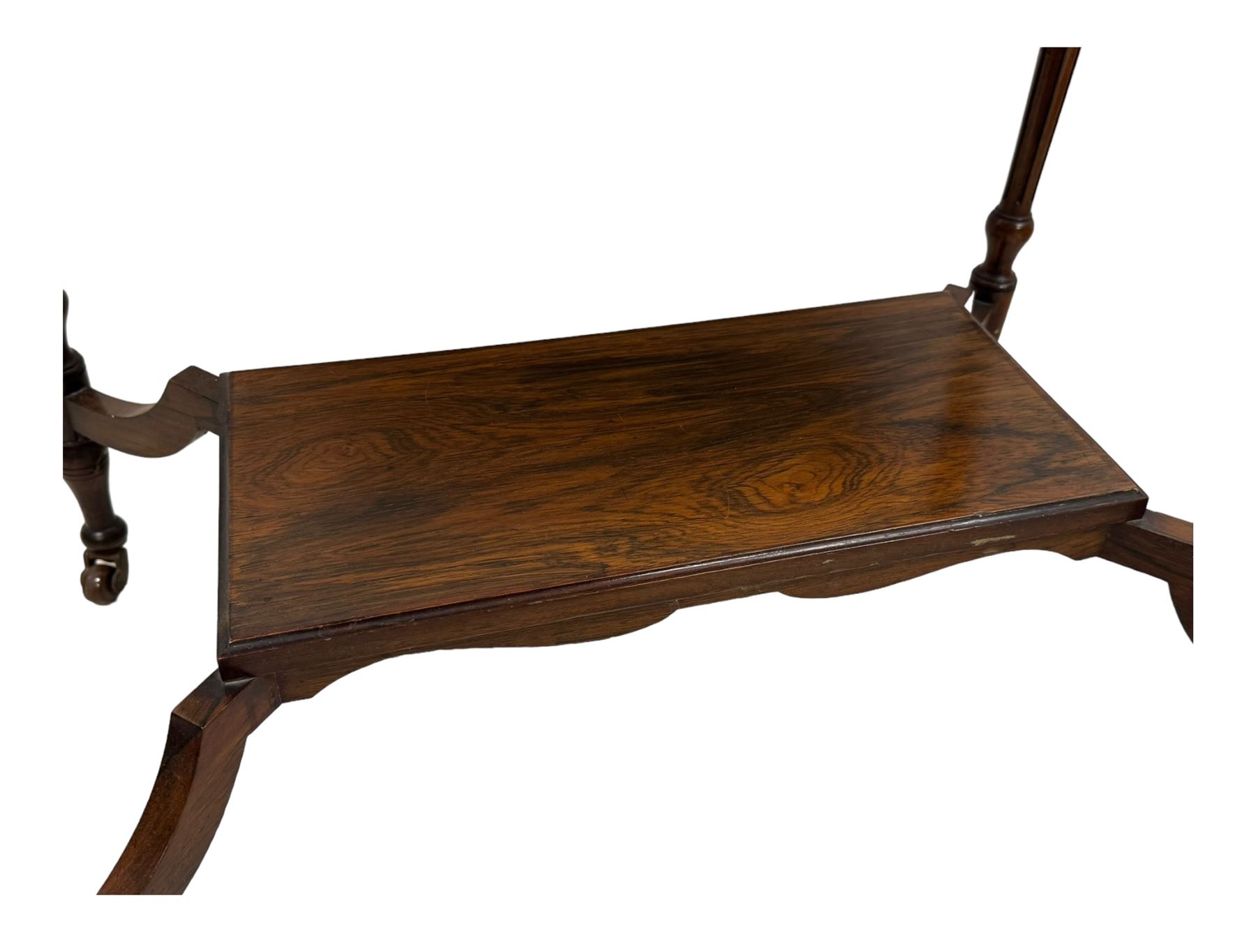 Late Victorian walnut writing table, rectangular leather-inset top surmounted by a brass gallery, fitted with a single frieze drawer, raised on turned tapering supports with lower undertier and ceramic castors