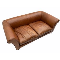 Two seat sofa, upholstered in tan leather, turned walnut feet
