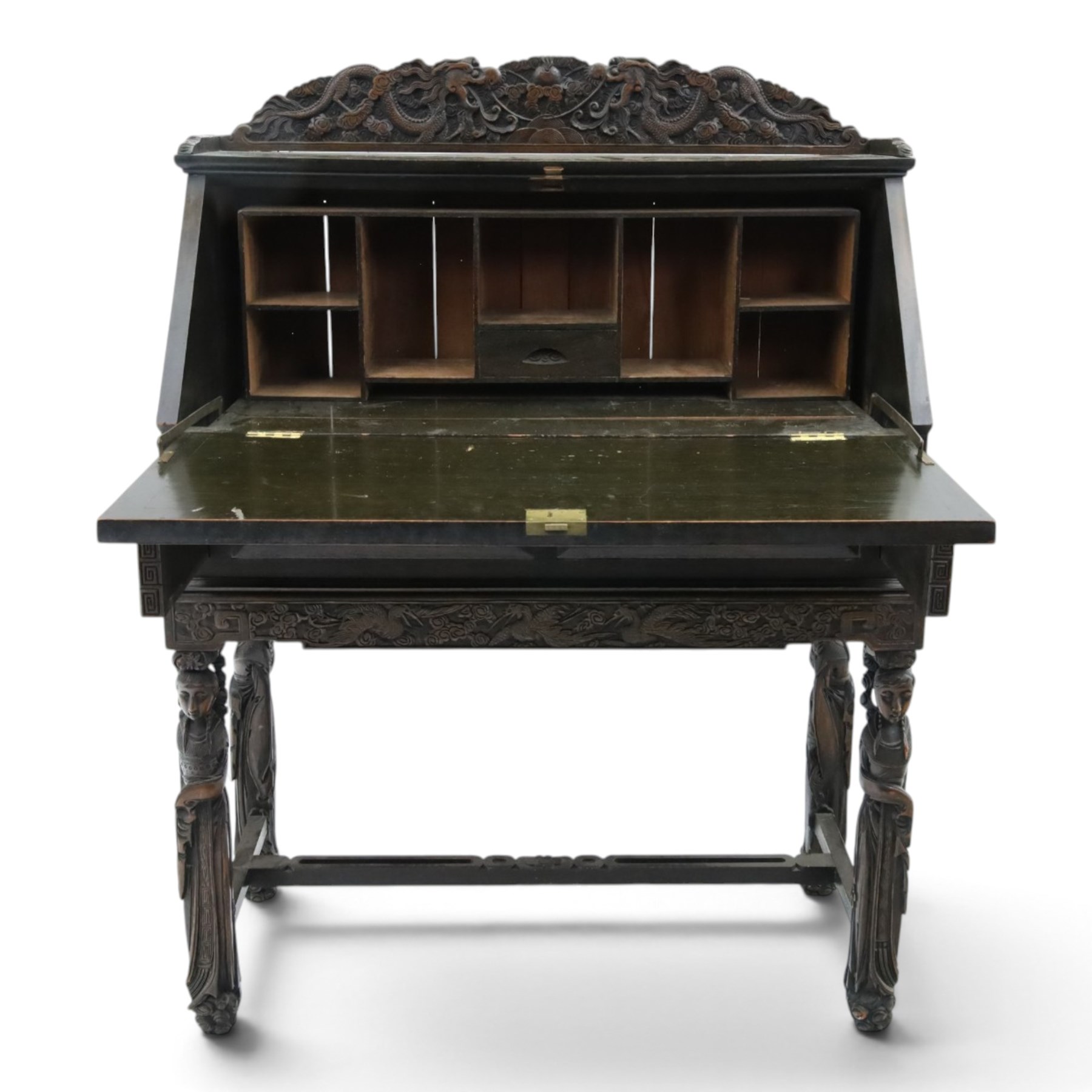 Early 20th century Chinese export carved hardwood writing bureau, the sloped fall front deeply carved with a narrative figural scene beneath pine and prunus trees, above a pair of rectangular carved panels, the shaped crest rail with entwined dragons, interior fitted with pigeonholes and a central drawer, on figural front supports with shaped stretcher