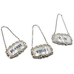 Set of three modern silver and enamel wine labels, each with shell and acanthus border, detailed in blue enamel 'Brandy', 'Whisky', and 'Gin', hallmarked Birmingham 1977, makers mark P G Ltd, approximate gross weight 1.19 ozt (37.2 grams)