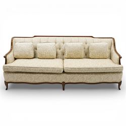 Mahogany framed three seat sofa in the Louis XV style, the shaped buttoned back above loose seat cushions and scrolling arms, raised on cabriole legs with shaped apron