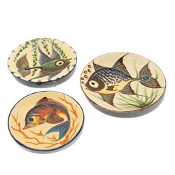 Puigdemont studio pottery slipware chargers, each uniquely decorated with stylised fish, largest D28cm 