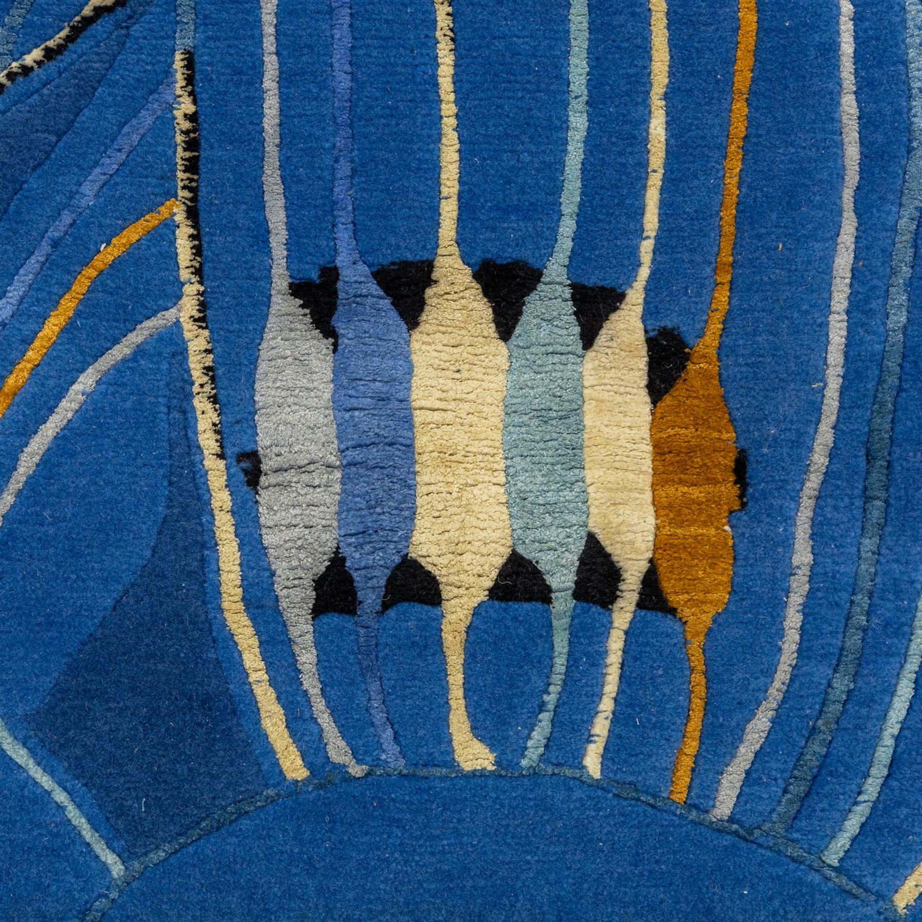 Rugs by Design - ‘Sweet Thames’ Nepalese thick pile wool rug, with abstract stylised floral design in layered blue tones, detailed with linear accents in cream, pale blue, black and ochre tones