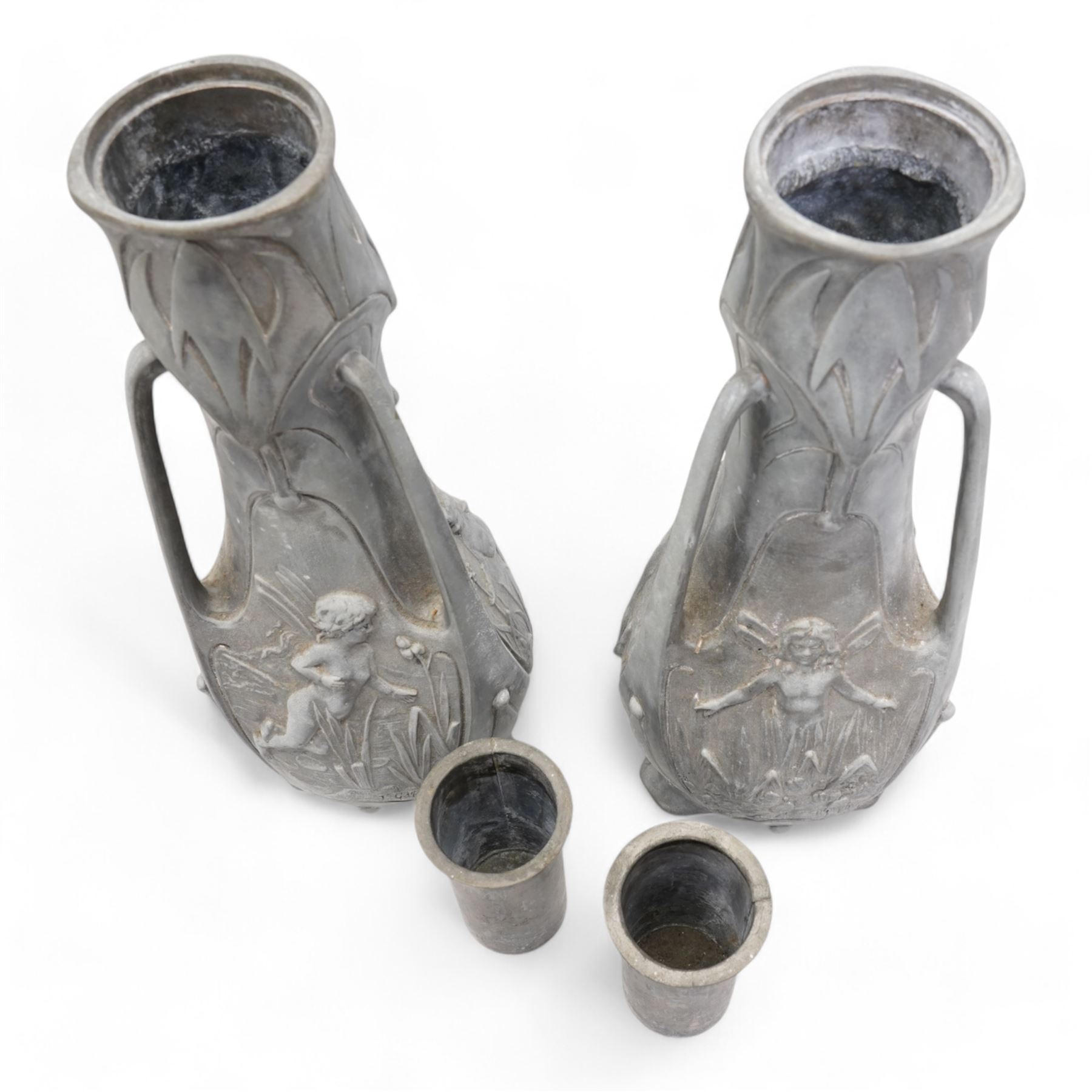 Jean Garnier (French 1853-1910): Pair of Art Nouveau cast metal vases, possibly spelter, of three handled form, cast in relief with panels of fairies, signed J. Garnier, H38cm 