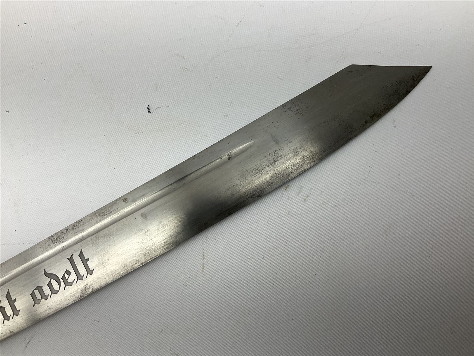 German Reichsarbeitdienst RAD Leader's Hewer dagger, the 26cm single edged scimitar shaped blade with narrow fuller, etched Arbeit adelt; by E.D. Wusthof, Solingen; the aluminium hilt with spade and wheat ear langet; two piece white plastic grip and eagle head pommel; pebbled steel scabbard engraved with ears of wheat and strapwork with double leather hangers L40cm overall