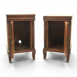  Pair of Regency mahogany bedside cabinets, rectangular top above a central cupboard door with flame mahogany veneer, flanked by spirally turned column uprights, raised on shaped supports
