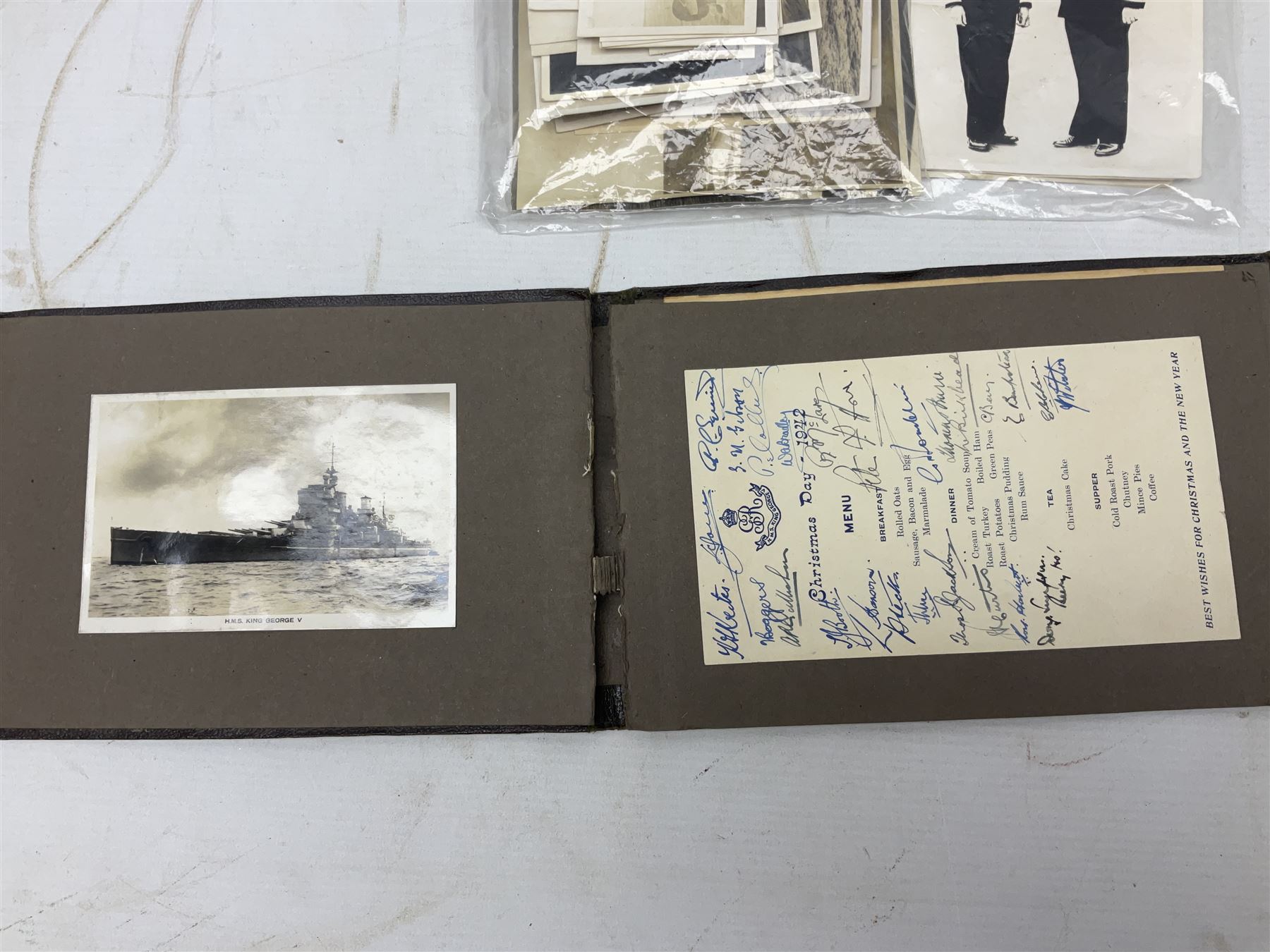 Disbound WW2 album relating to the battleship HMS King George VI containing over fifty various size loose photographs of the ship in action, guns firing, crew members, aircraft, two of George VI on board, three of Winston Churchill on board, official 1942 Christmas messages including Franklin Roosevelt etc; together with unrelated printed letter on 10 Downing Street notepaper from Winston Churchill; and Order of Service for Churchill's funeral at St. Paul's Cathedral 30th January 1965