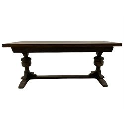 20th century oak drawer leaf extending dining table, two foliage carved baluster supports on sledge feet joined by floor stretcher 