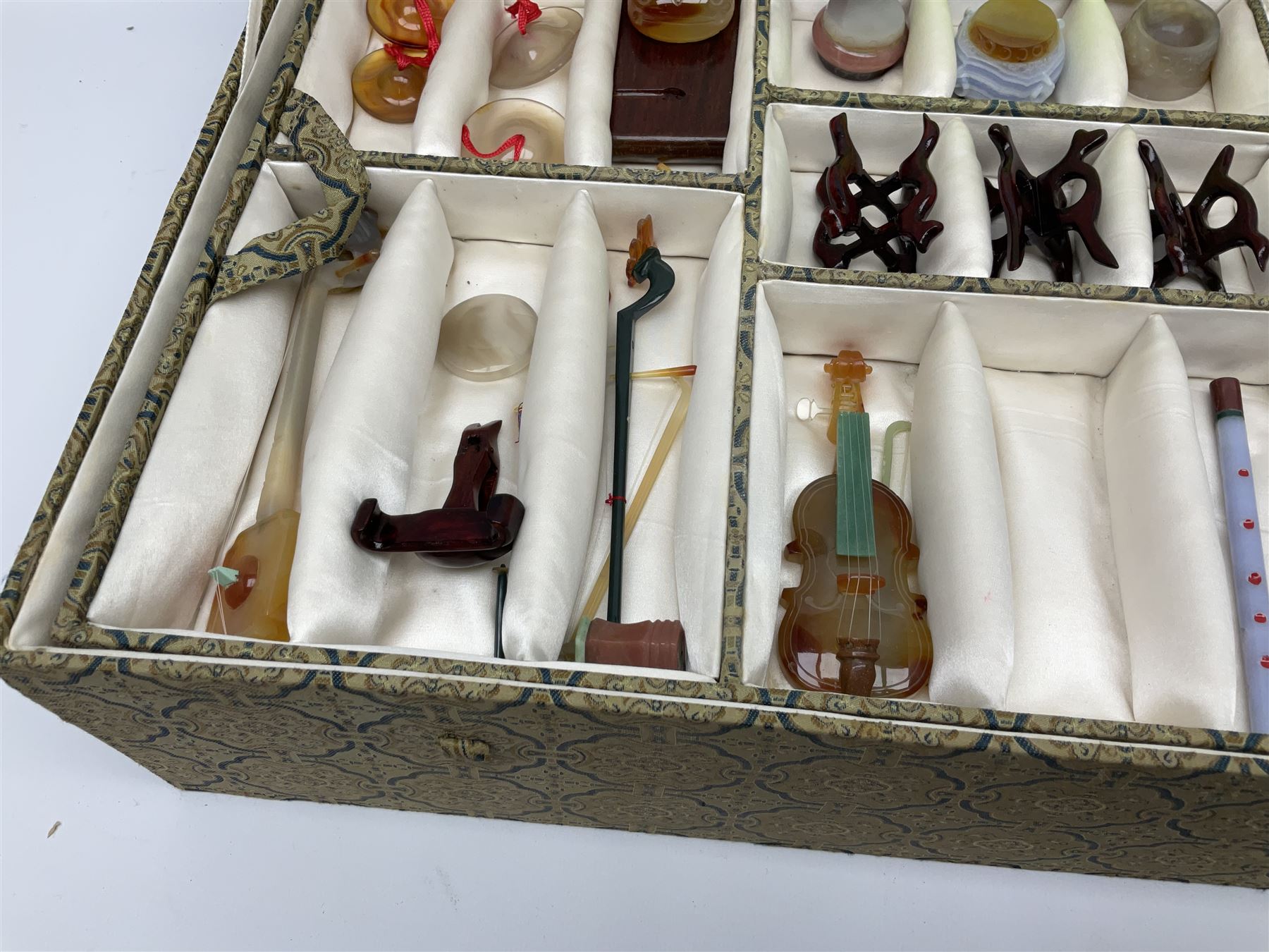 Chinese boxed collection of miniature polished hardstone musical instruments with hardwood stands