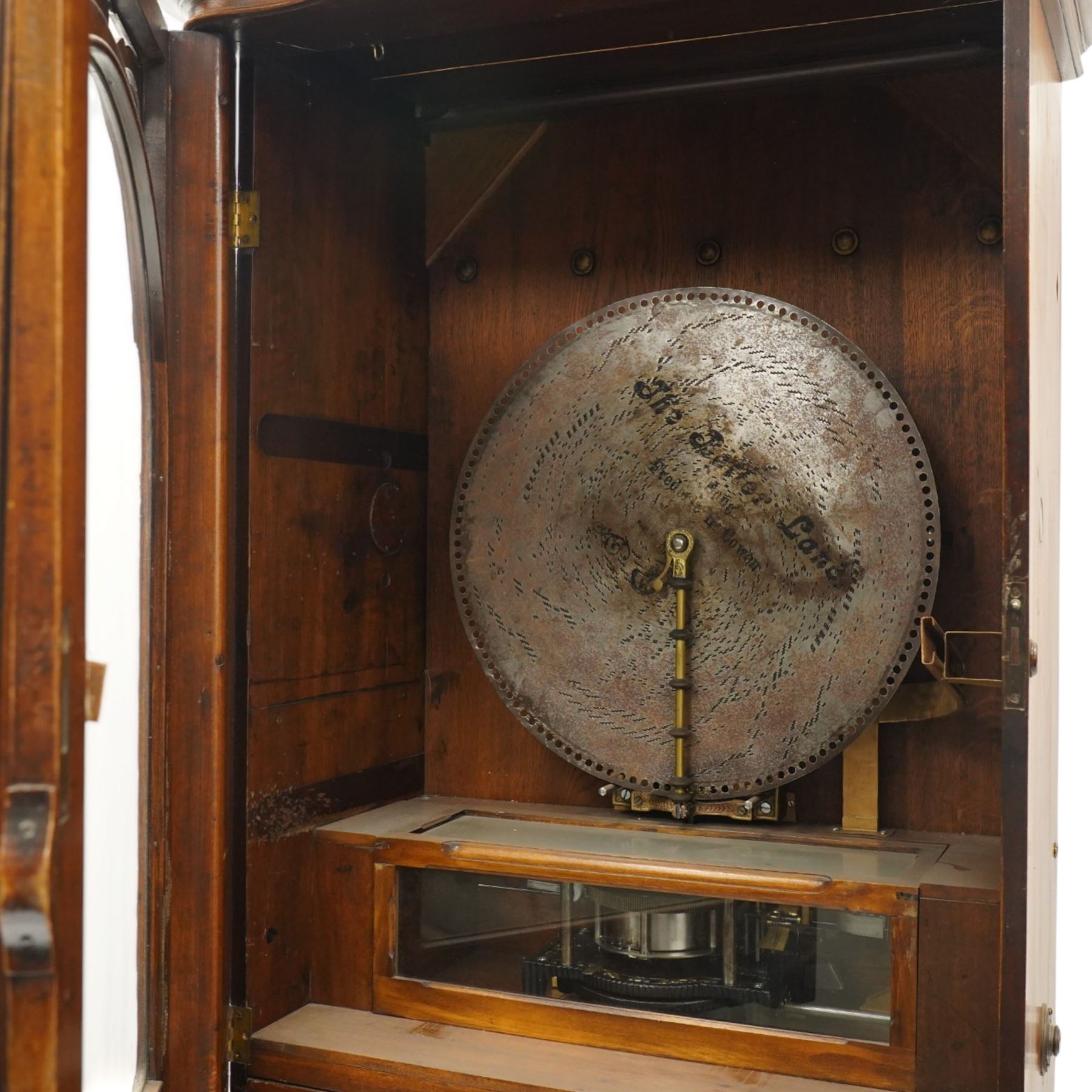 Late 19th century coin operated floor standing Polyphon, the shaped cornice marked 'Polyphon' with eleven 50cm discs in a walnut case with glazed upper section, the coin slot marked '1 Penny', the lower section with fall front for disc storage and inset with a portrait print and on compressed bun feet H230cm x W76cm x D46cm with a number of old pennies