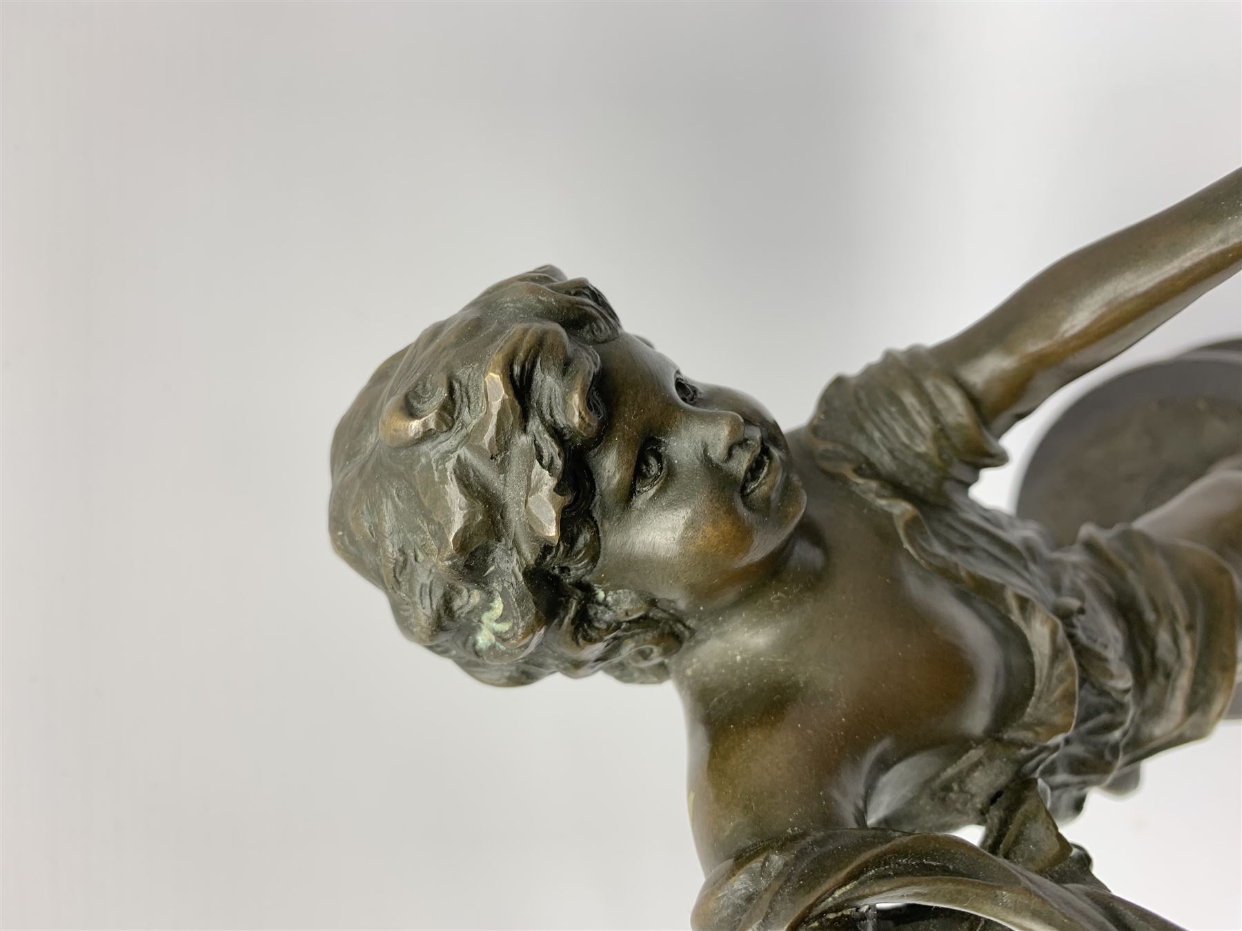 After E Plat, bronze modelled as a dancing child, signed E. Plat, upon cylindrical black marble base, H40cm