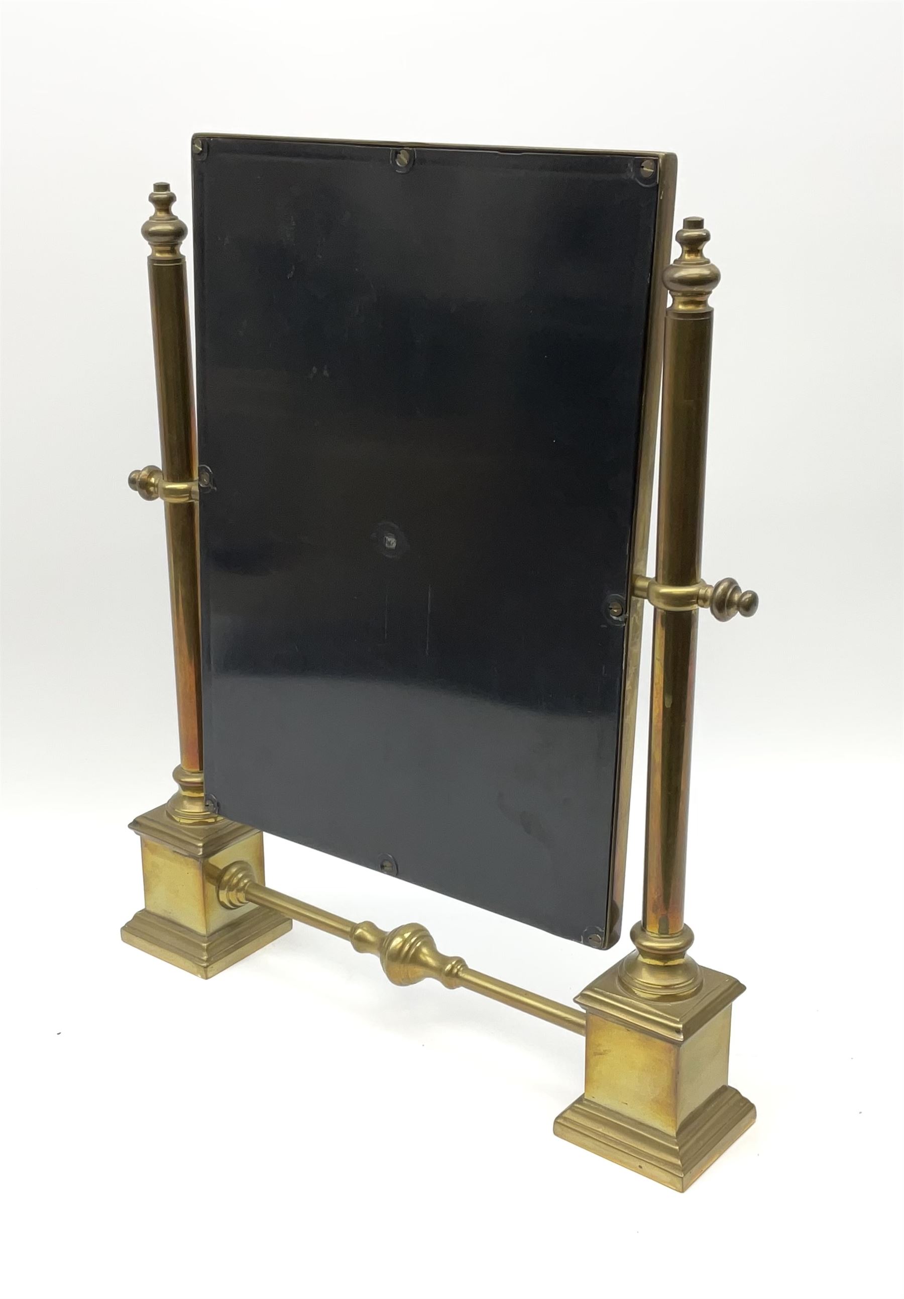 A brass table top swing mirror, upon stepped supports with stretcher, H41.4cm L34.5cm.