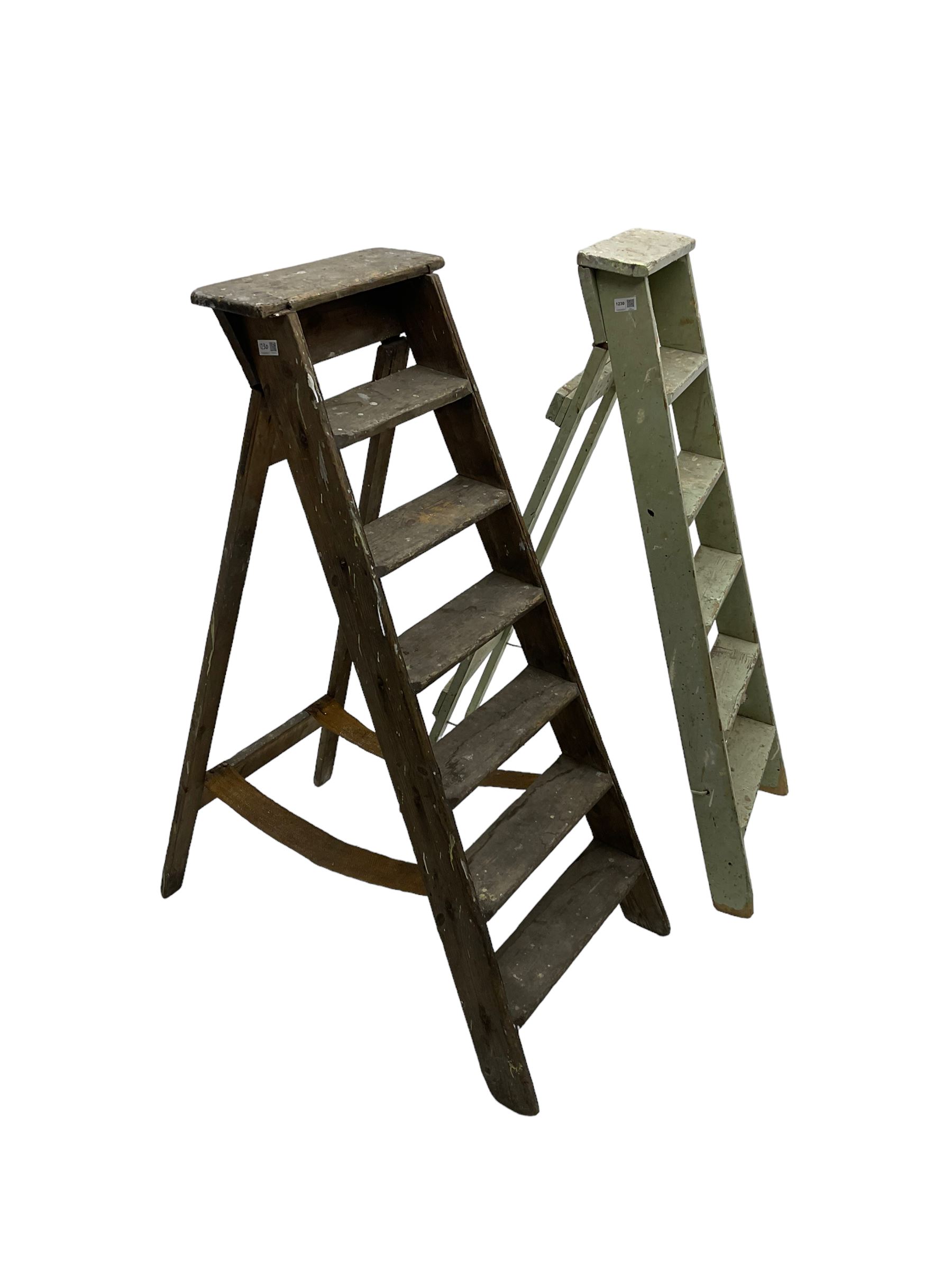 Early 20th century pine library or shop step ladder, seven tread (W45cm H135cm); together with another similar with painted laurel green finish (H135cm)