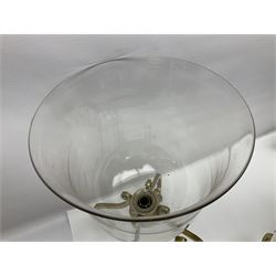 Four cylindrical glass candle holders, with fluted rim, upon four brass scrolling feet, H50cm