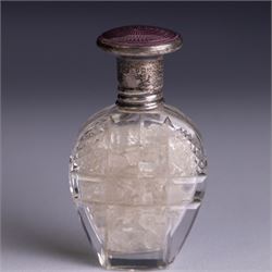 Three silver topped scent bottles, comprising cut glass example with pink guilloche enamel cover, oval example with blue guilloche enamel cover and one other, all hallmarked, largest H6.5cm