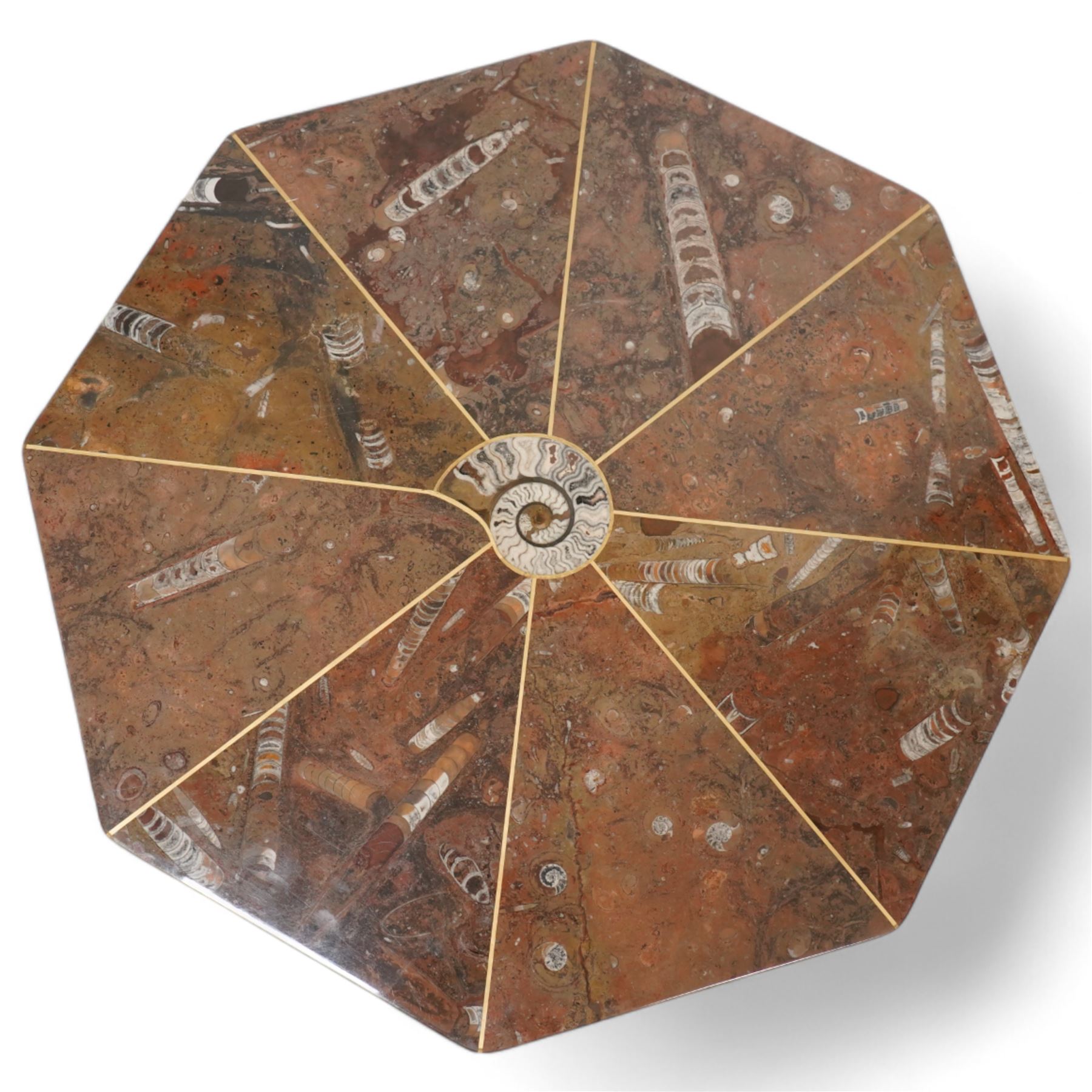 Octagonal specimen table with brass inlay, the limestone tabletop with a central ammonite and orthoceras and goniatite inclusions, upon a stepped octagonal base 