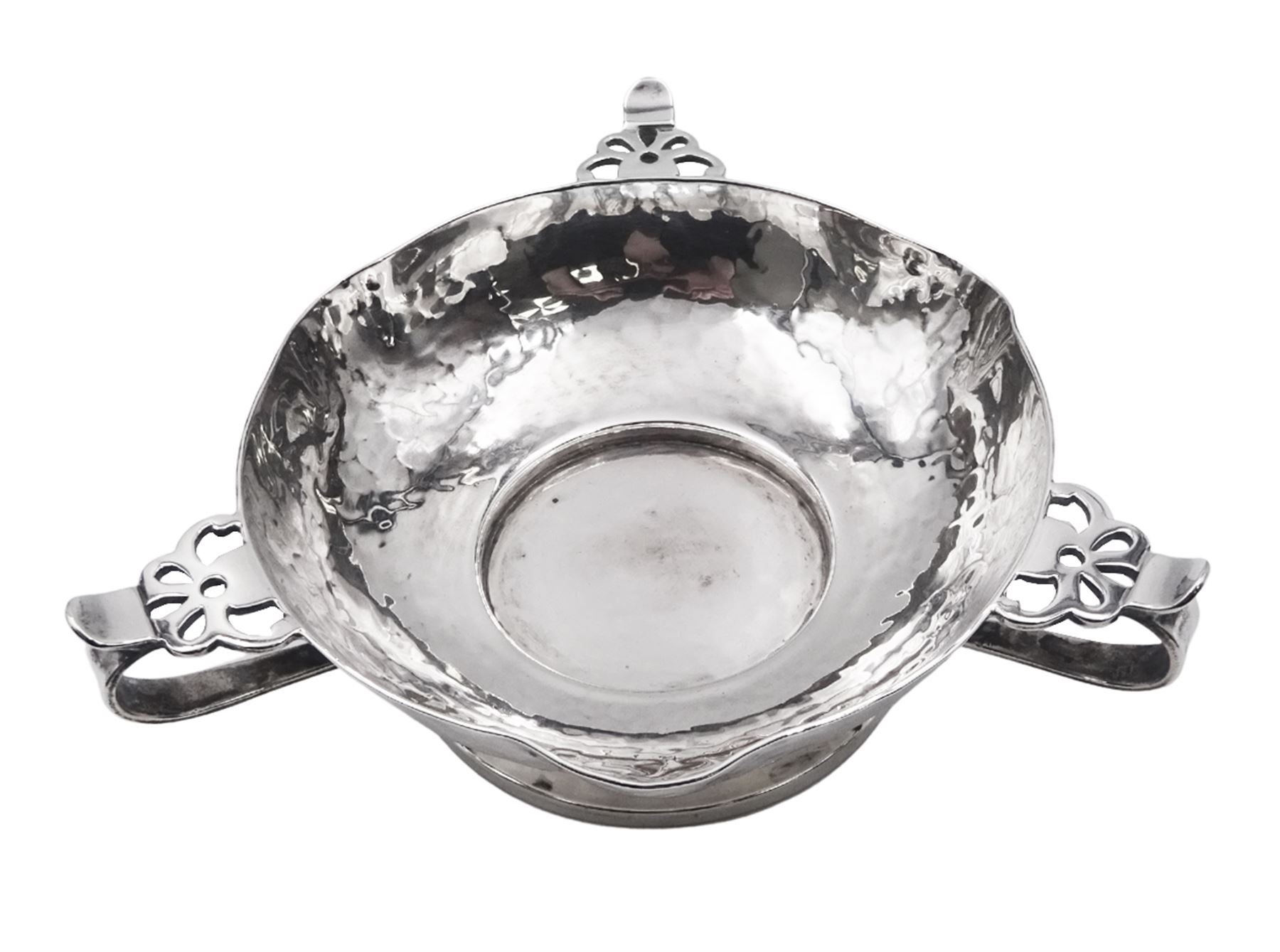 Arts & Crafts silver bowl, the planished bowl of circular form with three lips to rim, and three flower head capped curved handles, upon a circular spreading foot, hallmarked Charles Edwards, London 1904, 5.5cm D13cm, approximate weight 8.81 ozt (274 grams)