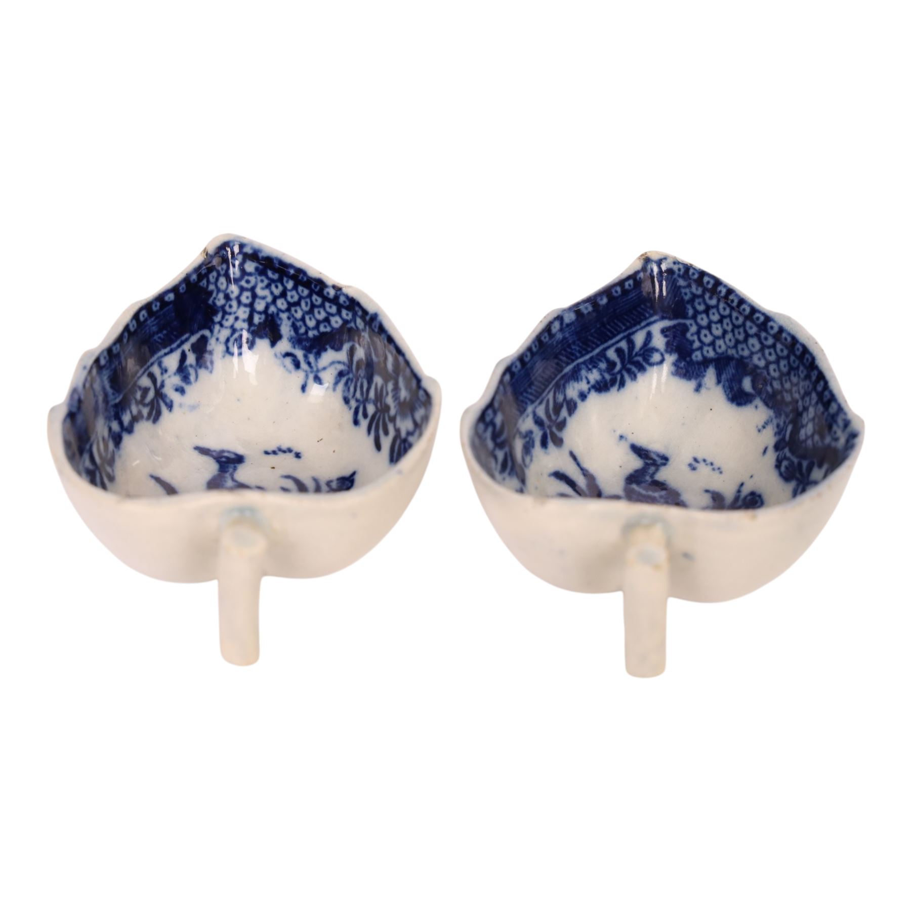 Pair of 18th century Derby blue and white leaf-shaped butter boats with stalk handles, internally decorated with a bird with in a foliage boarder, H3cm 