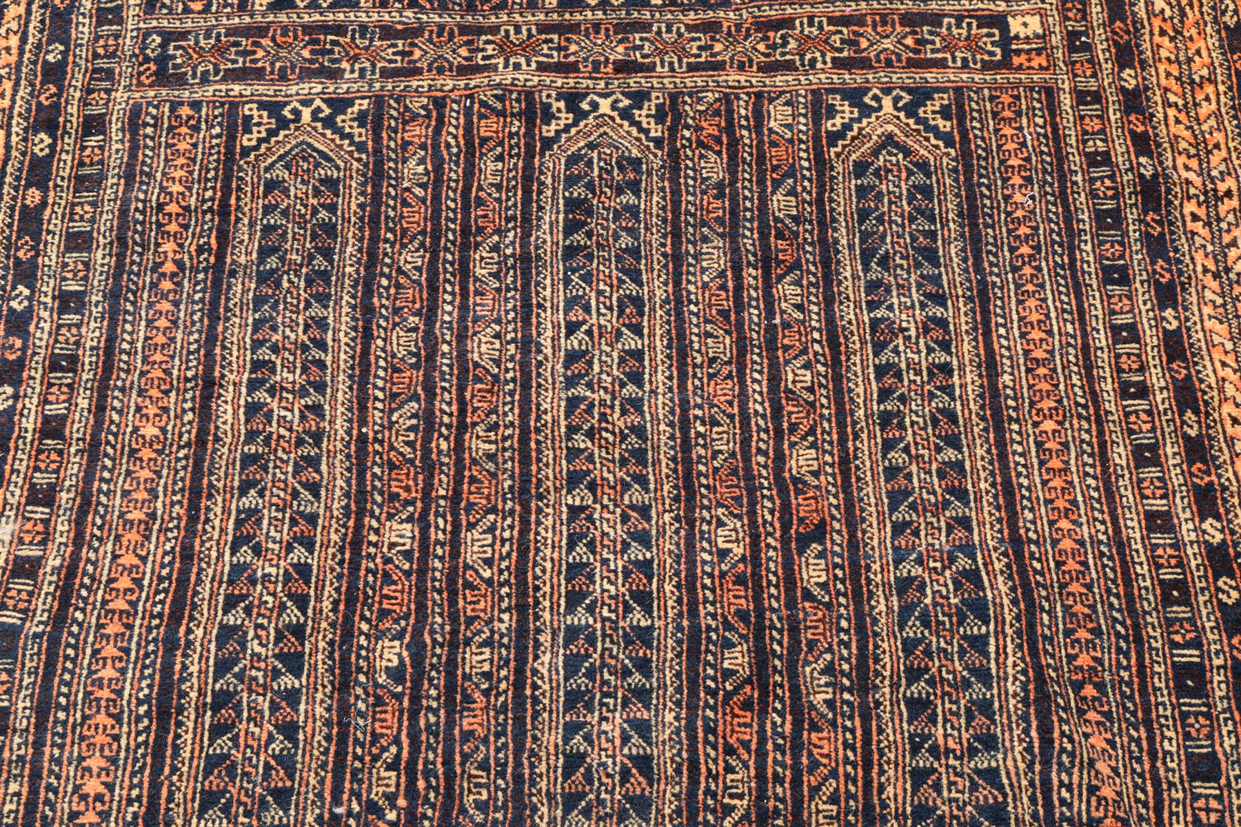 North Persian indigo ground tribal rug, the field decorated with stylised geometric motifs within vertical rows, the guard stripes with repeating hook motifs