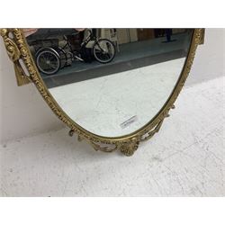 Ornate brass wall mirror with oval plate, L78cm