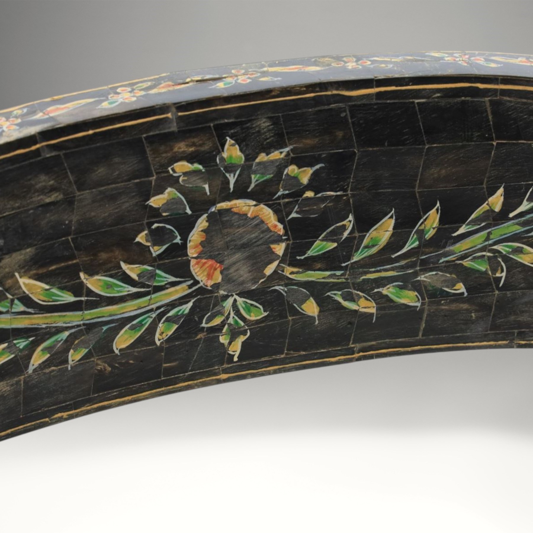 Early 20th century Anglo-Indian painted and inlaid armchairs, each with shaped top rail decorated with polychrome floral motifs above turned spindle galleries, shaped open arms and upholstered seats, on square supports with similar painted decoration