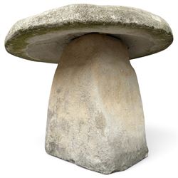 Weathered cast stone two-piece staddle stone of squat form, domed circular top over square-tapering pedestal base