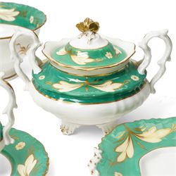 19th century porcelain tea service decorated with a border pattern of yellow leaves on a green ground comprising twelve cups and saucers, tea pot, sucrier and cover, milk jug, slop bowl and three plates, pattern number 5850