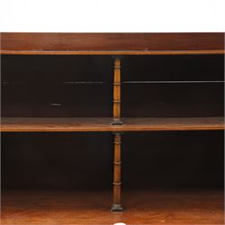 Regency period mahogany waterfall-bookcase chiffonier, the raised back with two open shelves supported by central ring-turned pilasters, fitted with twin doors with sage-green pleated fabric facias, over two drawers with satinwood stringing, raised on front sabre supports