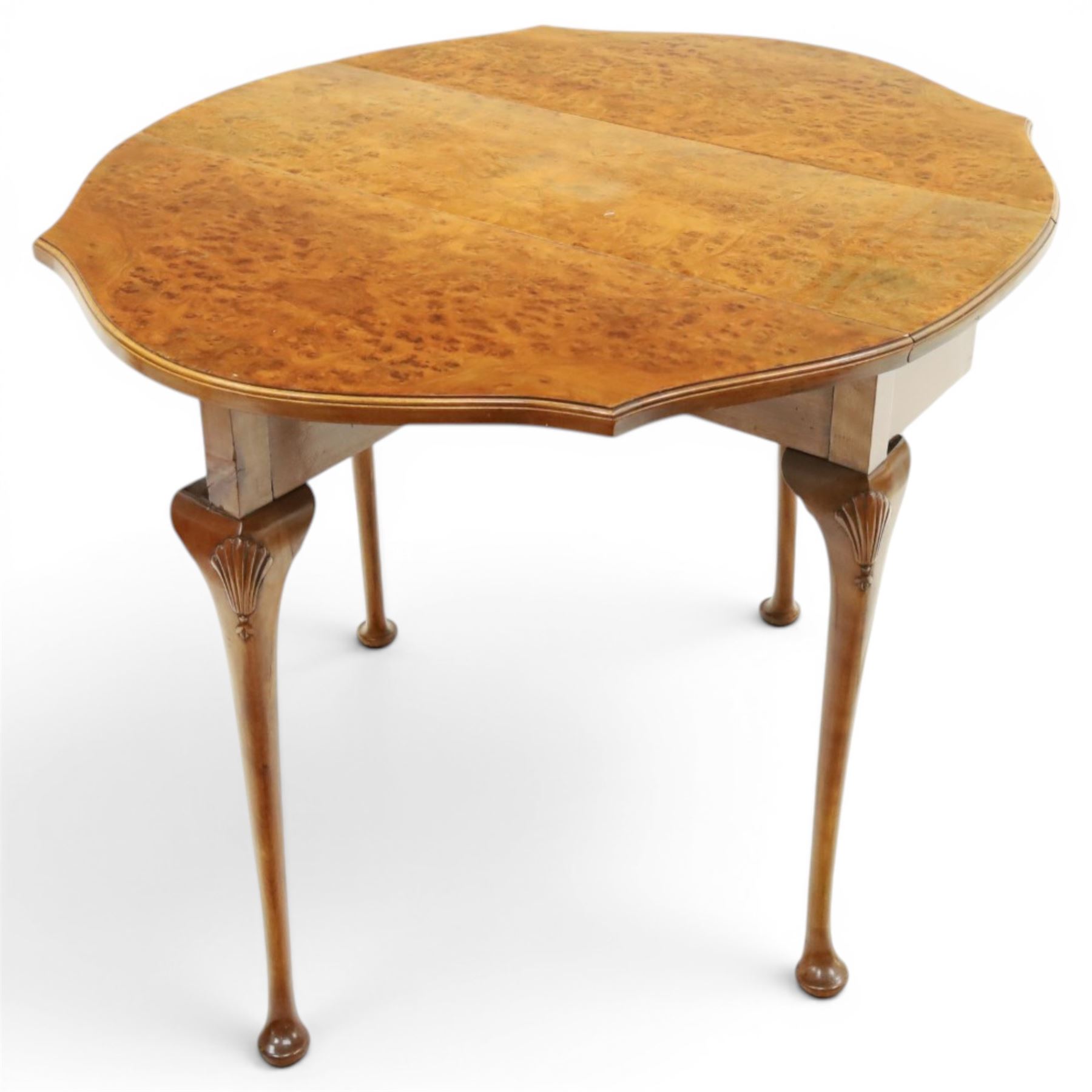 Queen Anne design walnut drop-leaf table, figured top with serpentine drop leaves, shell carved knees on cabriole supports