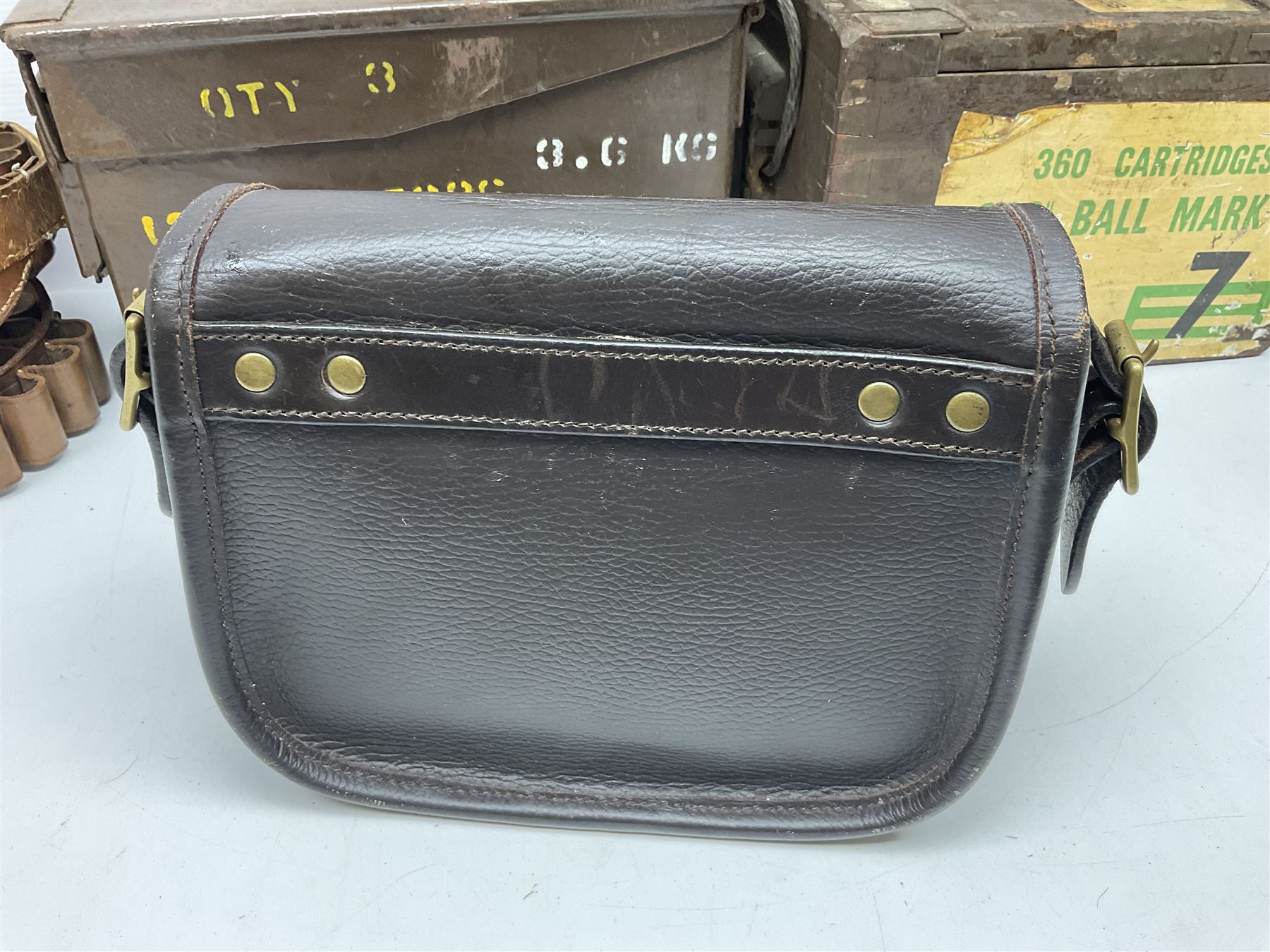 Miscellaneous shooting accessories - W.J. Bowman & Sons clay pigeon launcher; two leather cartridge belts; three cartridge bags; two canvas/leather game bags; and two metal/wooden cartridge boxes